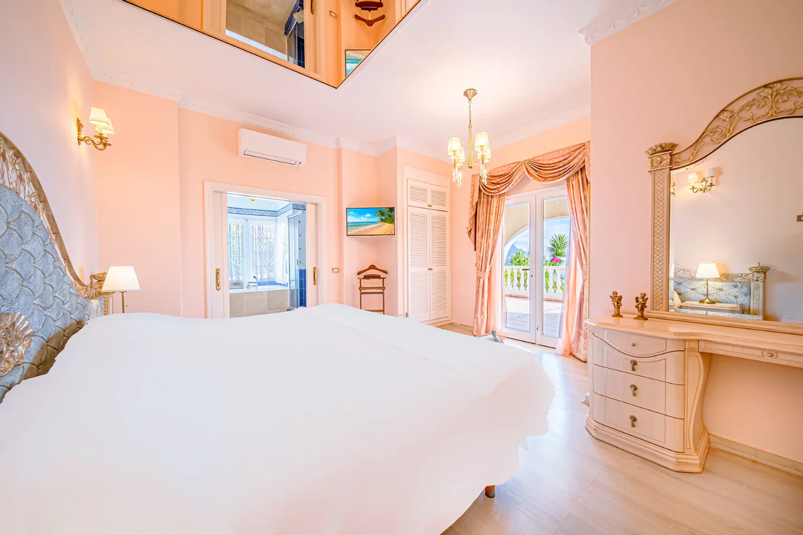 Pink ground-floor bedroom suite with terrace access at Villa Solea
