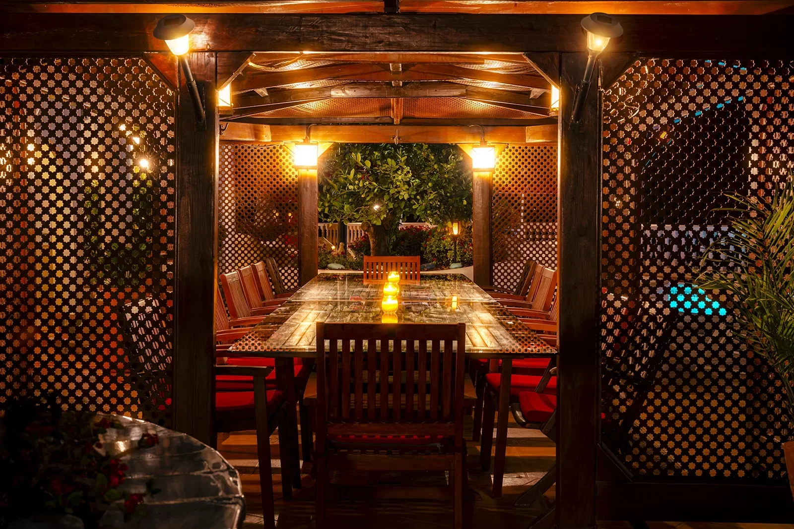 Pergola dining area prepared for an evening meal at Villa Solea